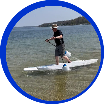 A man is standing on a surfboard in the water.