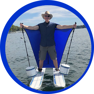 A man standing on top of a paddle board.