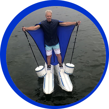 A man standing on top of two water skis.